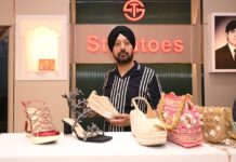 Stelatoes Expands Footprint in Rajasthan with a New Store Launch in Jaipur A man in a striped shirt and black turban standing behind a counter displaying luxury women's footwear and ethnic handbags at a Stettoes store.