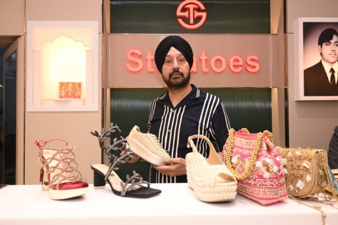 From Bridal Heels to Ethnic Bags: A First Look at the New Season Range by Stettoes A man in a striped shirt and black turban standing behind a counter displaying luxury women's footwear and ethnic handbags at a Stettoes store.