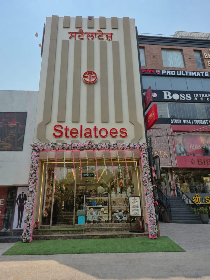 Exterior view of the new decorated Stelatoes footwear store in Jalandhar with floral decorations and Punjabi signboard.