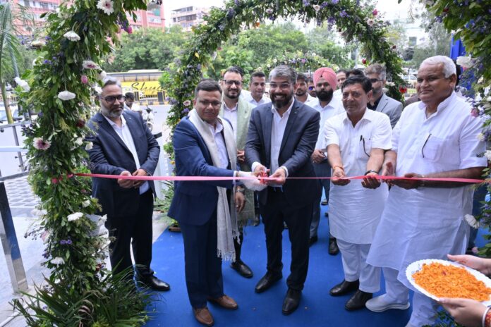 VinFast Velocity Sikar Road Jaipur Showroom Ribbon Cutting Ceremony Sudipta Ghosh, Sitaram Yadav, and Vikas Yadav cutting ribbon at VinFast Velocity Sikar Road Jaipur showroom inauguration